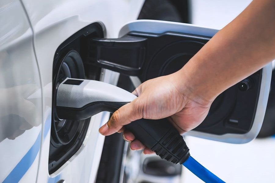 Hand plugging in electric vehicle charging cable